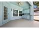 Cozy covered patio with a ceiling fan, built-in cabinets, and a view of the backyard at 2204 Hammock Moss Dr, Orlando, FL 32820