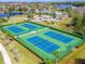 Aerial view of tennis courts and community amenities with nearby lake at 2204 Hammock Moss Dr, Orlando, FL 32820