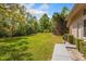 View of the expansive back yard with lush greenery, mature trees and a large grassy area at 2733 Deer Berry Ct, Longwood, FL 32779