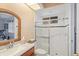 Bright bathroom featuring glass enclosed shower, single vanity, and skylight at 2733 Deer Berry Ct, Longwood, FL 32779