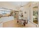 Bright dining area featuring a glass table with views of the kitchen and outdoor space at 2733 Deer Berry Ct, Longwood, FL 32779