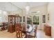 Formal dining room featuring a large window, elegant chandelier, and display cabinet at 2733 Deer Berry Ct, Longwood, FL 32779