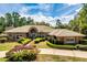 Stunning brick home with a tan tile roof and meticulously manicured landscaping at 2733 Deer Berry Ct, Longwood, FL 32779