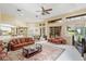 Bright and airy living room with large windows, neutral tones, and comfortable leather seating area at 2733 Deer Berry Ct, Longwood, FL 32779