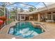 Enclosed in-ground pool and spa with screened enclosure offers a private outdoor oasis and patio at 2733 Deer Berry Ct, Longwood, FL 32779