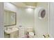 Powder room with floral wallpaper, pedestal sink, round window, and mirror at 2733 Deer Berry Ct, Longwood, FL 32779