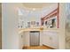 A wet bar featuring white cabinetry and a mini-fridge adjacent to the living room at 2733 Deer Berry Ct, Longwood, FL 32779