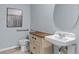 Cozy bathroom featuring neutral wall color, vanity, sink, mirror and commode at 2907 Moulin Rd, Davenport, FL 33837