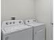 Close-up of a white Whirlpool washing machine and dryer in a laundry room at 2907 Moulin Rd, Davenport, FL 33837