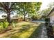 Backyard view featuring a private pool, well-maintained landscaping, and a classic wooden fence at 2952 Ashwood Ct, Apopka, FL 32703