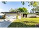 Charming single-story home with stone accents, a well-manicured lawn, and an attached garage at 2952 Ashwood Ct, Apopka, FL 32703