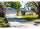 Inviting single-story home with stone and painted accents, a garage, and well-kept lawn at 2952 Ashwood Ct, Apopka, FL 32703