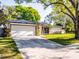 A single-story home features stone accents, a metal roof, and a driveway at 2952 Ashwood Ct, Apopka, FL 32703