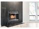 A modern fireplace with black tile and hardwood flooring is featured at 2952 Ashwood Ct, Apopka, FL 32703