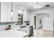 Modern kitchen with stainless steel appliances, quartz countertops, and white subway tile backsplash at 2952 Ashwood Ct, Apopka, FL 32703