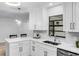 Bright kitchen boasts white cabinets, stainless steel appliances, and a window view at 2952 Ashwood Ct, Apopka, FL 32703