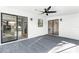 Covered patio with ceiling fan and sliding glass doors to the home's interior at 2952 Ashwood Ct, Apopka, FL 32703