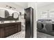 Charming bathroom with patterned tile floor, vessel sinks, and modern lighting, adjacent to the laundry area at 337 Ohio Ave, St Cloud, FL 34769