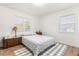 Bright bedroom with two windows, a floral patterned bedspread, and wooden floors at 337 Ohio Ave, St Cloud, FL 34769