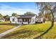 Inviting exterior showcasing a home with a porch and a beautifully manicured lawn at 337 Ohio Ave, St Cloud, FL 34769