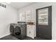 Well-lit laundry room with front-load washer/dryer and door to the exterior at 337 Ohio Ave, St Cloud, FL 34769