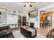 Inviting living room showcasing a fireplace, mounted television, tile flooring, and seamlessly connected kitchen at 337 Ohio Ave, St Cloud, FL 34769