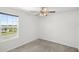 Neutral bedroom with carpet, ceiling fan and natural light from a large window at 3936 Fescue St, Clermont, FL 34714