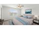 Bright bedroom featuring a ceiling fan, light gray furniture and soothing wall art at 3936 Fescue St, Clermont, FL 34714