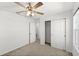 Cozy bedroom featuring plush carpet, ceiling fan, and ample closet space at 3936 Fescue St, Clermont, FL 34714