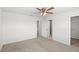 This spacious bedroom has neutral colors, a ceiling fan, and multiple entryways at 3936 Fescue St, Clermont, FL 34714