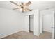 Bedroom features ceiling fan, closet, and neutral carpeting at 3936 Fescue St, Clermont, FL 34714