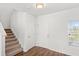 Bright foyer features hardwood floors, a staircase, and a window with natural light at 3936 Fescue St, Clermont, FL 34714