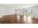 Spacious living room featuring wood floors, modern chandelier, and sliding glass doors at 3936 Fescue St, Clermont, FL 34714