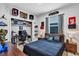 This stylish bedroom includes a black bedspread, skateboard decor, and a desk with gaming equipment at 3964 Lightning Ct, Sanford, FL 32773