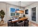 Modern dining area features a wooden table, unique lighting, and a view of the backyard at 3964 Lightning Ct, Sanford, FL 32773