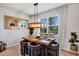 An inviting dining room boasts a wooden table, stylish chairs, pendant lighting, and natural light from a large window at 3964 Lightning Ct, Sanford, FL 32773