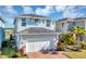 Two-story home with brick driveway and tidy lawn with a majestic palm tree accenting the facade at 3964 Lightning Ct, Sanford, FL 32773