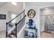 A foyer shows hardwood steps, a staircase with white bannisters, and an art piece near the bathroom entrance at 3964 Lightning Ct, Sanford, FL 32773