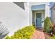 Inviting entryway features a blue door, brick walkway, and lush landscaping, creating a warm welcome at 3964 Lightning Ct, Sanford, FL 32773