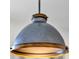 Close-up view of a stylish pendant light fixture with metallic and wooden accents at 3964 Lightning Ct, Sanford, FL 32773