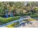 Fun community playground featuring a slide, swing set, and climbing structures, surrounded by lush greenery at 3964 Lightning Ct, Sanford, FL 32773