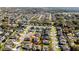 Expansive aerial shot of a residential neighborhood with homes surrounded by lush greenery at 420 Lone Heron Way, Winter Garden, FL 34787