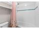 Bright bathroom with white subway tile, a shower curtain, and shelving for storage and decor at 420 Lone Heron Way, Winter Garden, FL 34787