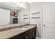 Well-lit bathroom with a dark vanity with granite countertop and ample storage space at 420 Lone Heron Way, Winter Garden, FL 34787