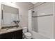 Well-lit bathroom with a shower-tub combo, decorative accent tile, and a vanity with granite countertop at 420 Lone Heron Way, Winter Garden, FL 34787