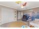 Cozy bedroom with neutral carpet, decorative wall art, white trim and ample closet space at 420 Lone Heron Way, Winter Garden, FL 34787