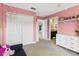 Pink bedroom with neutral carpet, white closet, and drawers, perfect for or young adult at 420 Lone Heron Way, Winter Garden, FL 34787