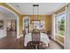 Elegant dining room with modern lighting, decorative wallpaper, and hardwood floors at 420 Lone Heron Way, Winter Garden, FL 34787