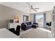 Comfortable living room with a blue sofa and natural light from a window at 420 Lone Heron Way, Winter Garden, FL 34787