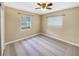 Bedroom with carpet flooring, ceiling fan, and large windows to let in natural light at 46 Morning Glory Dr, Debary, FL 32713